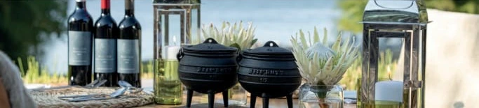 Potjie pots and wine on a dinner table at The Eatery waterfront
