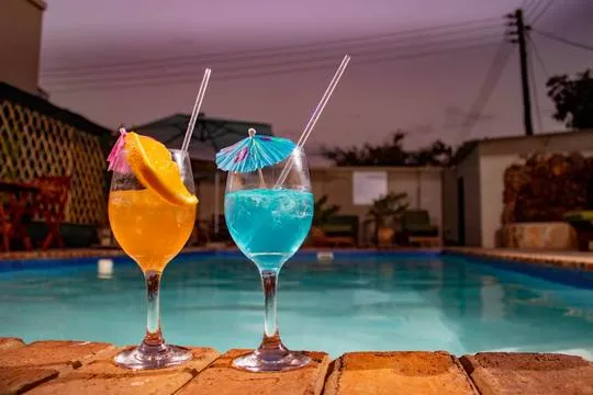 Colourful poolside cocktails for two at a Victoria Falls lodge
