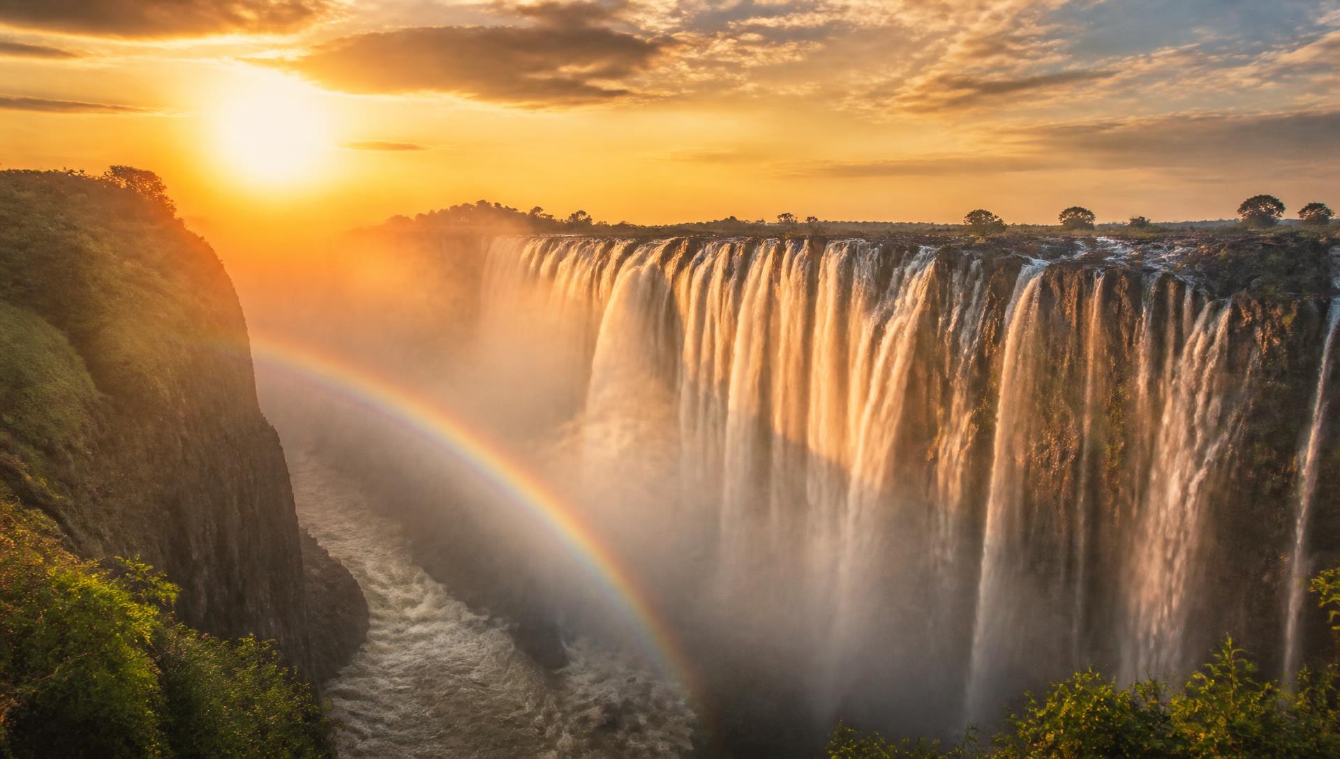 Victoria Falls with a rainbow over the mist filled gorge